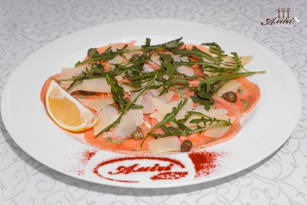 Salmon carpaccio with arugula, capers and Parmesan cheese