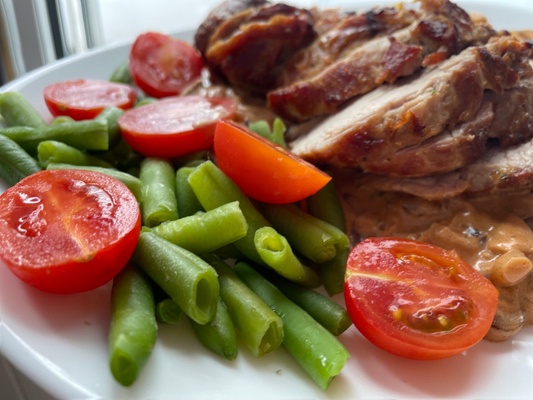 Pork in mushroom sauce with asparagus and cherry tomatoes