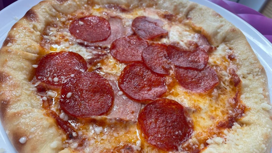 Pizza with cheese edges and salami